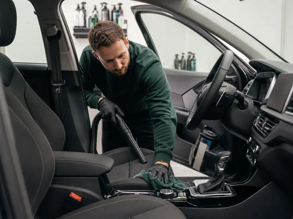 Valeter polishing a car interior