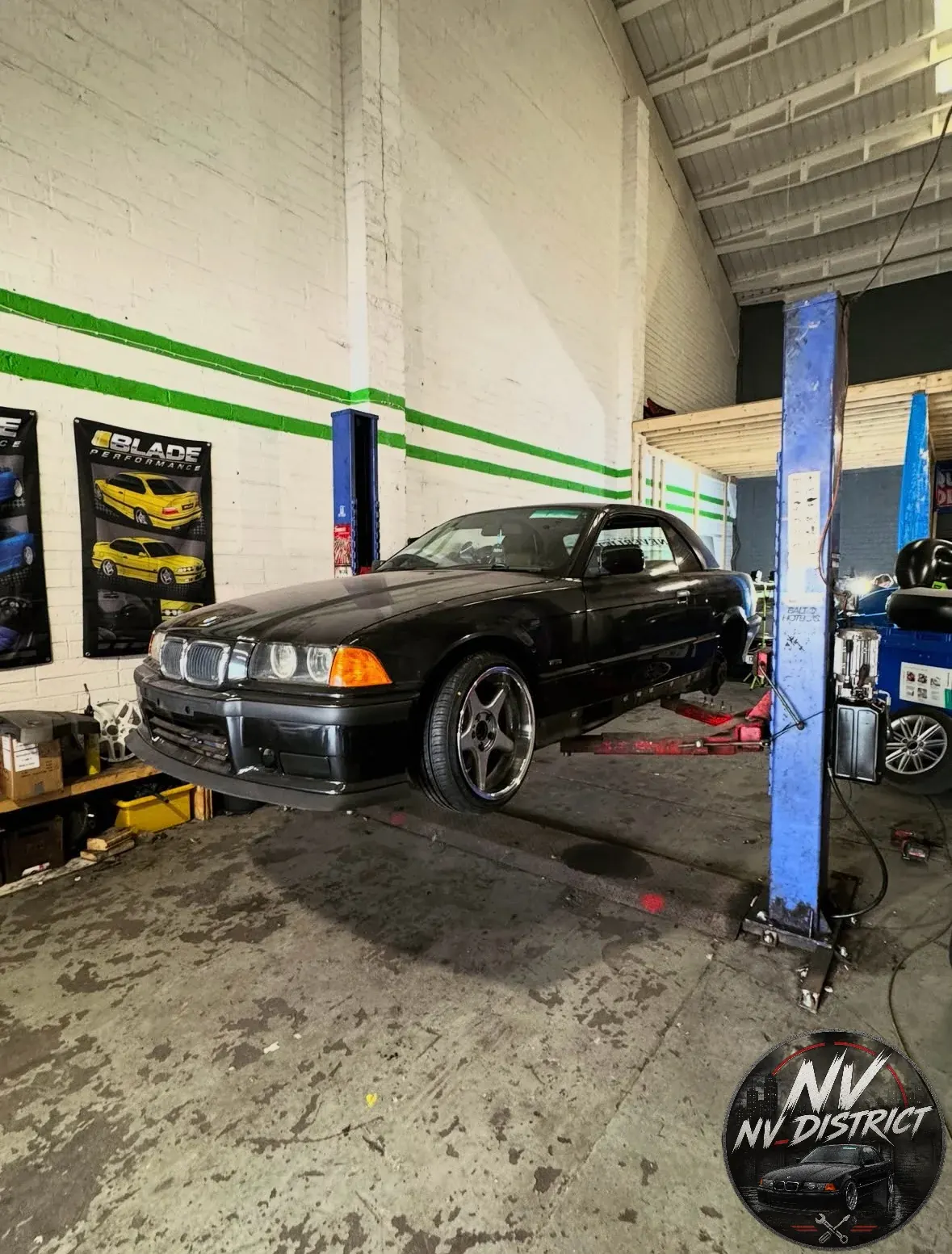 A BMW E36 on a workshop lift at NV District in Drogheda